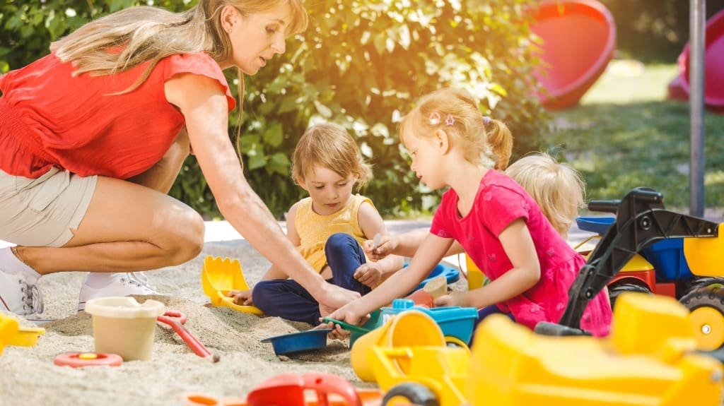 Kids Playing Together in the Backyard Sandbox - Playset Transformations